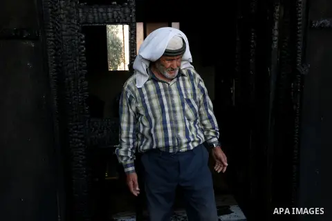 A Palestinian man inspects a house that was badly damaged from a suspected attack by Jewish extremists on two houses at Kafr Duma village near the West Bank city of Nablus July 31, 2015. The house had been empty and ther...