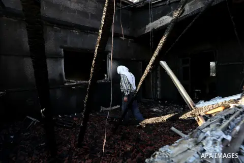 A Palestinian man inspects a house that was badly damaged from a suspected attack by Jewish extremists on two houses at Kafr Duma village near the West Bank city of Nablus July 31, 2015. The house had been empty and ther...