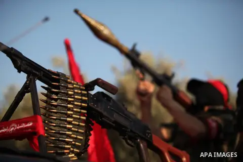 A masked Palestinian militant of the National Resistance Brigades, a group linked to the Democratic Front for the Liberation of Palestine holds his weapon during a military parade against the killing of a 18-month-old Pa...