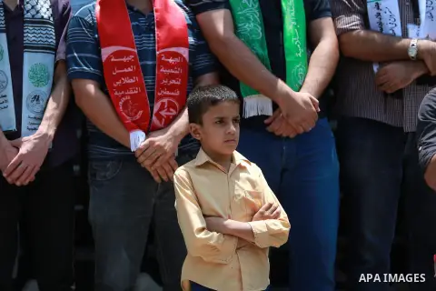Palestinian students take part in a protest against the killing of a 18-month-old Palestinian toddler Ali Dawabsheh in Duma village, in Gaza city on August 1, 2015. Photo by Ashraf Amra