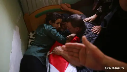 Mourners gather around the body of Palestinian youth Laith al-Khaldi during his funeral near the West Bank city of Ramallah August 1, 2015. Al-Khaldi died on Saturday at a West Bank hospital following a clash with Israel...