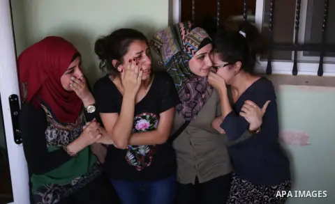 Palestinian women mourn during the funeral of Palestinian youth Laith al-Khaldi near the West Bank city of Ramallah August 1, 2015. Al-Khaldi died on Saturday at a West Bank hospital following a clash with Israeli troops...