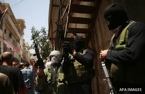 Palestinian militants fire their weapons during the funeral of Palestinian youth Laith al-Khaldi near the West Bank city of Ramallah August 1, 2015. Al-Khaldi died on Saturday at a West Bank hospital following a clash wi...