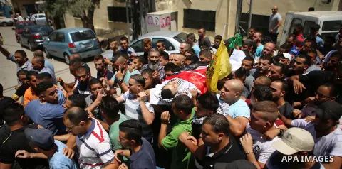 Mourners carry the body of Palestinian youth Laith al-Khaldi during his funeral near the West Bank city of Ramallah August 1, 2015. Al-Khaldi died on Saturday at a West Bank hospital following a clash with Israeli troops...