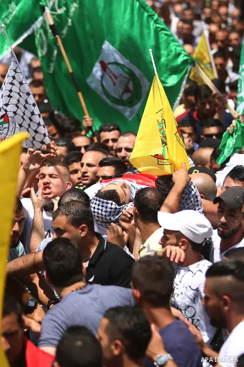 Mourners carry the body of Palestinian youth Laith al-Khaldi during his funeral near the West Bank city of Ramallah August 1, 2015. Al-Khaldi died on Saturday at a West Bank hospital following a clash with Israeli troops...