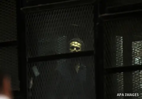 Egyptian radical Islamist Mohammed al-Zawahiri, the brother of Al-Qaeda chief Ayman al-Zawahiri, sits in the defendants cage during his trial with 68 other defendants, at a court in Cairo on August 01, 2015. Photo by Amr...