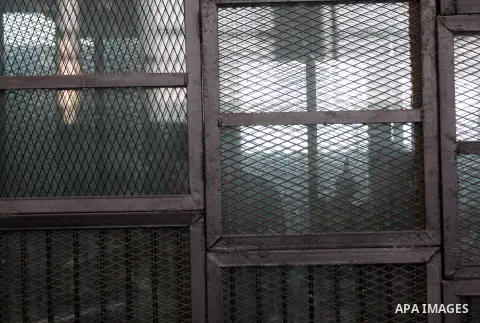 Egyptian radical Islamist Mohammed al-Zawahiri, the brother of Al-Qaeda chief Ayman al-Zawahiri, sits in the defendants cage during his trial with 68 other defendants, at a court in Cairo on August 01, 2015. Photo by Amr...