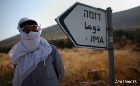A Palestinian protester poses for a picture during clashes at the entrance to Duma village near the West Bank city of Nablus, Saturday, Aug. 1, 2015. Tensions remain high after suspected Jewish assailants set fire to a W...