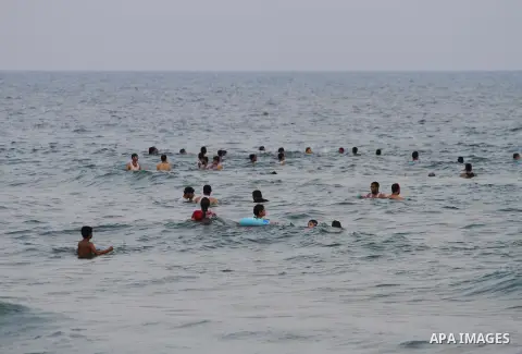 Palestinians enjoy the warm weather on a beach along the Mediterranean Sea in Gaza city, on August 2, 2015. Photo by Mohammed Asad