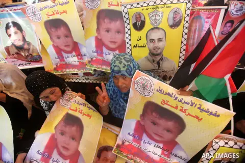 Palestinians take part in a protest demanding release the prisoners in Israeli jails, in front of Red cross office, in Gaza city, on on August 03, 2015. Photo by Ashraf Amra