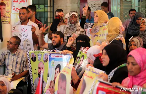Palestinians take part in a protest demanding release the prisoners in Israeli jails, in front of Red cross office, in Gaza city, on on August 03, 2015. Photo by Ashraf Amra