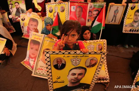 Palestinians take part in a protest demanding release the prisoners in Israeli jails, in front of Red cross office, in Gaza city, on on August 03, 2015. Photo by Ashraf Amra