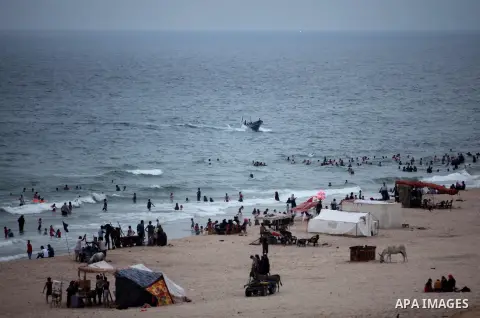 Palestinians enjoy the beach of the Mediterranean Sea on the coast of Gaza City on August 4, 2015. Across the Middle East, temperatures in the high 30’s Centigrade (upper 90’s Fahrenheit) and as high as 50 (122 Fahrenhei...