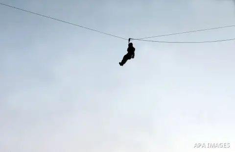 A Palestinian youth demonstrates his skills during a graduation ceremony of a military-style camp organized by the Hamas movement in Khan Younis in the southern Gaza Strip, on August 5, 2015. Hamas's armed wing organized...