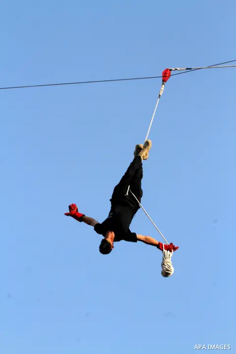 A Palestinian youth demonstrates his skills during a graduation ceremony of a military-style camp organized by the Hamas movement in Khan Younis in the southern Gaza Strip, on August 5, 2015. Hamas's armed wing organized...