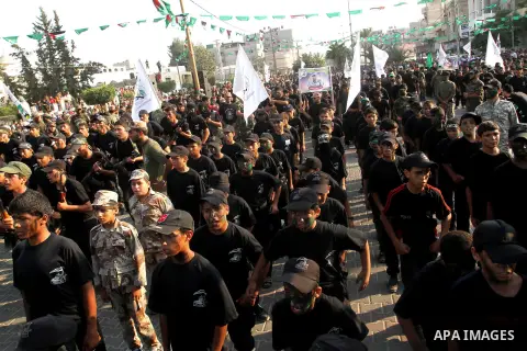 Palestinian youths take part in a graduation ceremony of a military-style camp organized by the Hamas movement in Khan Younis in the southern Gaza Strip, on August 5, 2015. Hamas's armed wing organized ''Liberation Youth...