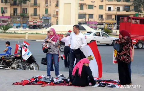 Supporter of Egyptian President Abdel-Fattah el-Sissi celebrate for Thursday's opening of the new extension of the Suez Canal, at Tahrir square in Cairo, on August 5, 2015. Egypt will unveil a major extension of the Suez...