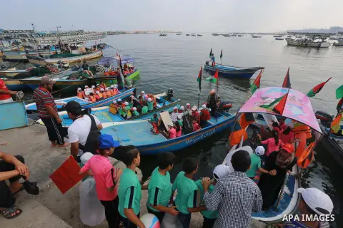 Palestinian childern take part a protest against the killing of 18-month-old Palestinian Ali Saad Dawabsheh, the toddler who was burned to death by suspected Jewish extremists, at the Seaport of Gaza city, on August 6, 2...