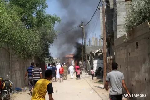 Palestinians gather at the site of an explosion that ripped through a house in the Al-Shabura refugee camp near the southern Gaza Strip town of Rafah on August 6, 2015. The blast killed at least two people and wounded 20...