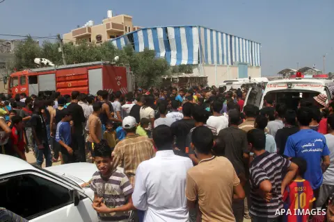 Palestinians gather at the site of an explosion that ripped through a house in the Al-Shabura refugee camp near the southern Gaza Strip town of Rafah on August 6, 2015. The blast killed at least two people and wounded 20...