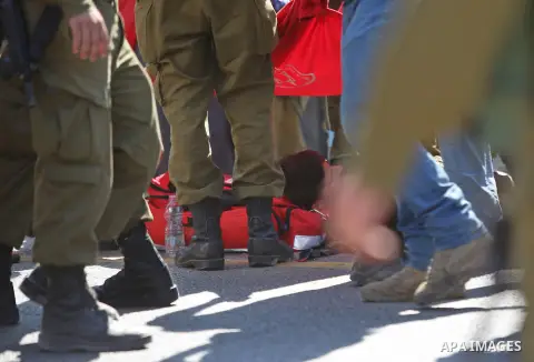 Israeli medics treat a wounded man following rammed in a suspected attack by a Palestinian motorist, near the West Bank city of Ramallah on August 6, 2015. Israeli forces shot and injured a Palestinian man on Thursday af...