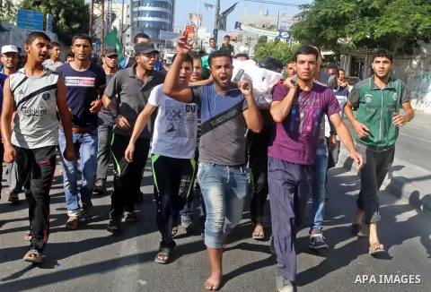 Mourners carry a body of one of three victims from Abu Nuqeira family, who were killed in an explosion that ripped through a house in the Al-Shabura refugee camp near the southern Gaza Strip town of Rafah, during their f...