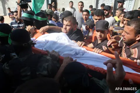 Mourners carry a body of one of three victims from Abu Nuqeira family, who were killed in an explosion that ripped through a house in the Al-Shabura refugee camp near the southern Gaza Strip town of Rafah, during their f...