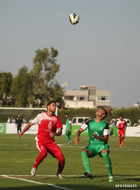 Palestinian Gaza's Shejaya players and Hebron's Al-Ahly players compete during the first leg match of the Palestine Cup final at Yarmuk stadium in Gaza City, on August 6, 2015, as the two teams play each other for the fi...