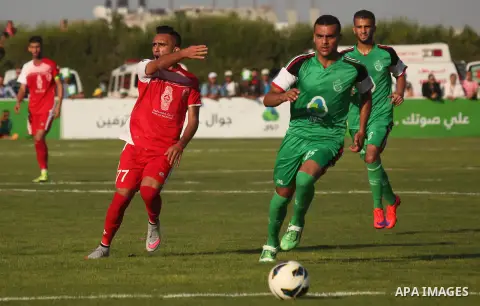 Palestinian Gaza's Shejaya players and Hebron's Al-Ahly players compete during the first leg match of the Palestine Cup final at Yarmuk stadium in Gaza City, on August 6, 2015, as the two teams play each other for the fi...
