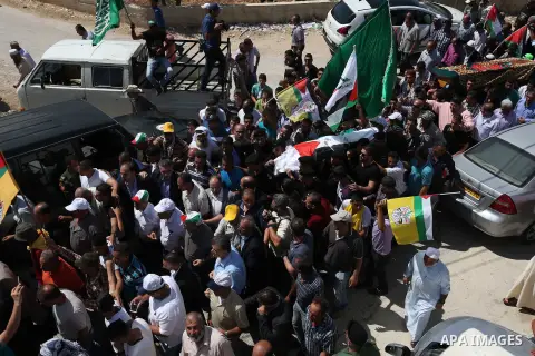 Palestinian mourners carry the body of Saad Dawabsha, the father of a Palestinian toddler killed last week when their home was firebombed by Jewish extremists, during his funeral in the West Bank village of Duma on Augus...