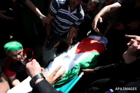 Palestinian mourners carry the body of Saad Dawabsha, the father of a Palestinian toddler killed last week when their home was firebombed by Jewish extremists, during his funeral in the West Bank village of Duma on Augus...