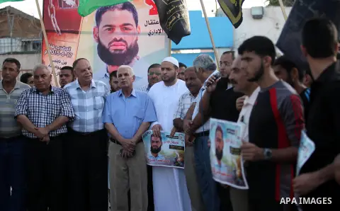 Protesters hold portraits of Palestinian prisoner in Israeli jails Mohammad Allan, during a protest outside United Nations headquarter, in Gaza city on August 8, 2015. The Israeli military prosecutor intends to request c...