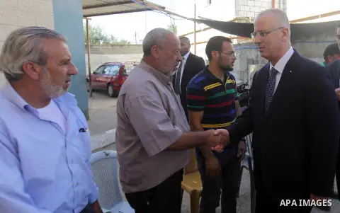 Palestinian Prime Minister Rami Hamdallah offers condolences to the Family of Palestinian Saad Dawabsha, the father of a Palestinian toddler killed last week when their home was firebombed by Jewish extremists, in Duma v...