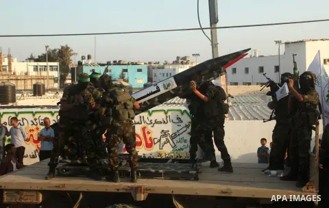 Members of Ezzedeen al-Qassam brigades, the armed wing of Hamas movement, take part in an anti-Israel parade in Beit Hanoun, in the northern Gaza Strip, on August 11, 2015. Photo by Ashraf Amra
