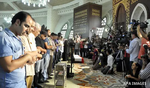 Friends and relatives of Egyptian actor Nur al-Sharif pray over his coffin during his funeral at a mosque in Sheikh Zayed City, on the outskirts of Cairo, on August 12, 2015. The veteran pan-Arab film and TV star died on...