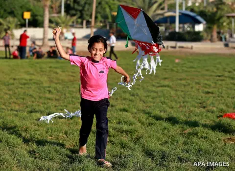 Palestinian children fly kites in a protest against the Israeli blockade on the Gaza Strip and demanding for opening the Rafah crossing, in Gaza city on August 12, 2015. Photo by Yasser Qudih