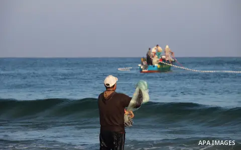 Palestinians ride a boat in the Mediterranean Sea on the coast of Gaza City on August 14, 2015. Photo by Khaled Dawood