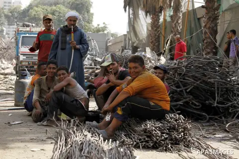 Egyptian laborers break during the demolition of the headquarters of the once-dominant party of ex-president Hosni Mubarak that was torched during the 2011 uprising that toppled him, on August 16, 2015 in the capital, Ca...