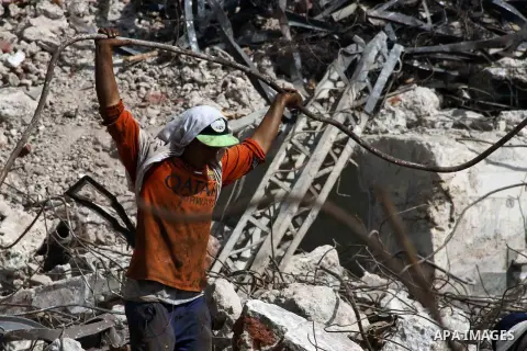 Egyptian laborers work during the demolition of the headquarters of the once-dominant party of ex-president Hosni Mubarak that was torched during the 2011 uprising that toppled him, on August 16, 2015 in the capital, Cai...