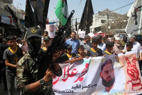 Members of Islamic Jihad take part in a protest to solidarity with prisoner Mohammad Allan allegedly being held in an Israeli jail, in Rafah in the southern Gaza Strip on August 16, 2015. Allan has been on hunger strike...
