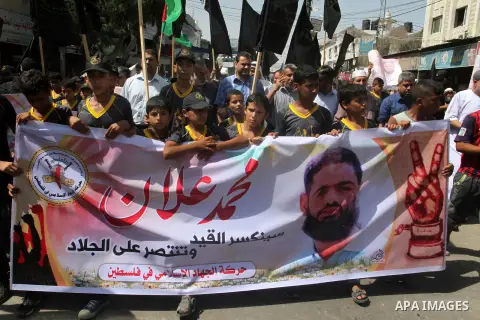 Palestinian children hold pictures of prisoner Mohammad Allan allegedly being held in an Israeli jail, during a march organized by the Islamic Jihad in Rafah in the southern Gaza Strip on August 16, 2015. Allan has been...