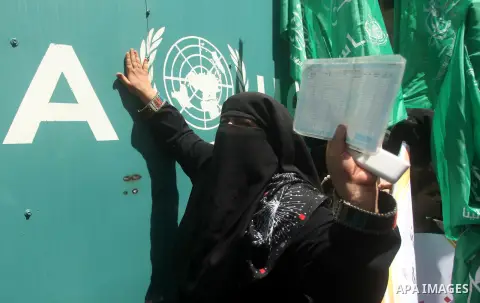 Palestinian women take part in a protest against possible reductions of the services and aid offered by United Nations Relief and Works Agency (UNRWA), in front of UNRWA headquarters in Gaza City August 16, 2015. Photo b...