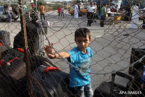 Palestinians wait for travel permits to cross into Egypt at the Rafah border crossing between Egypt and the southern Gaza Strip August 18, 2015. Egypt opened the Rafah border crossing on Monday for four days to allow Pal...