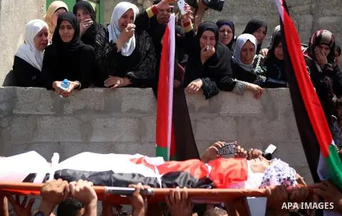Mourners carry the body of Palestinian man Mohammad El-Atrash during his funeral in the West Bank village of Kofr Raee near Jenin August 18, 2015. El-Atrash was shot dead on Monday by Israeli police troopers after he sta...