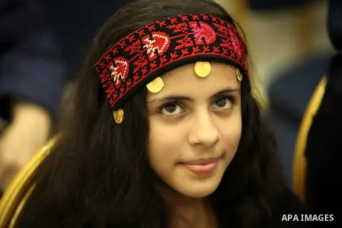 A Palestinian girl looks on as she watch members of musical band from "Edward Said National Conservatory of Music" perform in a festival of "Sea and Freedom" in Gaza city on August 22, 2015. Photo by Ashraf Amra