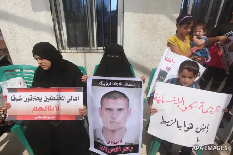 Palestinian families of abductees hold banners during a protest demanding released of four Palestinians were abducted in Egypt's Sinai Peninsula on Wednesday after the bus they were on was stopped by unidentified gunmen,...