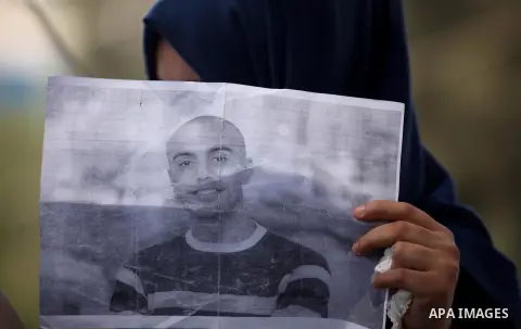 Palestinian families of abductees hold banners during a protest demanding released of four Palestinians were abducted in Egypt's Sinai Peninsula on Wednesday after the bus they were on was stopped by unidentified gunmen,...