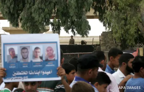 Families of Palestinians who were abducted of by gunmen is Egypt's Sinai's northern region, take part in a demonstration calling for the release at the Rafah border crossing with Egypt in the southern Gaza Strip, on Augu...