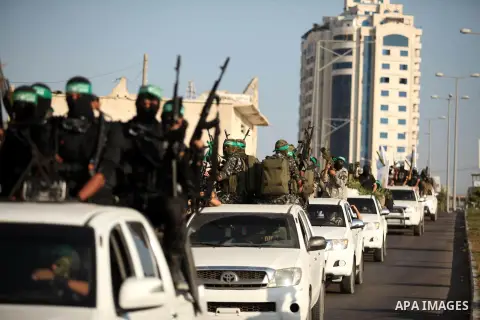 Palestinian militants of the Ezzedine al-Qassam Brigades, Hamas' armed wing, take part in a military parade in Gaza city on August 26, 2015. Photo by Ashraf Amra
