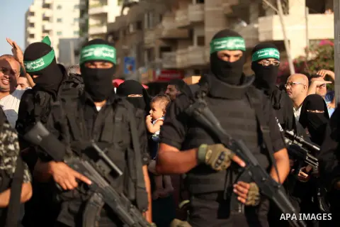 Palestinian militants of the Ezzedine al-Qassam Brigades, Hamas' armed wing, take part in a military parade in Gaza city on August 26, 2015. Photo by Ashraf Amra